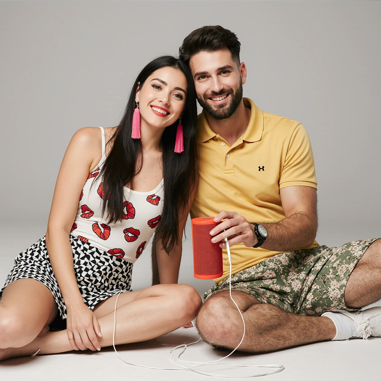 Stylish young couple enjoying music in Edgewater with a modern speaker